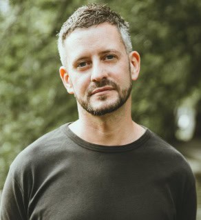 A person with a beard

Description automatically generated